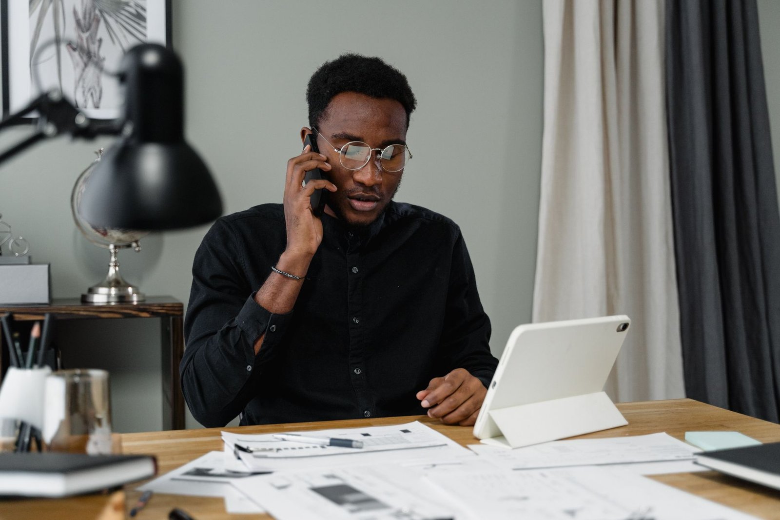 Person on the phone with paperwork, comparing COBRA continuation coverage with marketplace health plan options