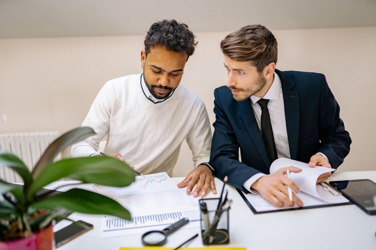 Two people reviewing financial assistance documents together, representing help applying for hospital financial assistance