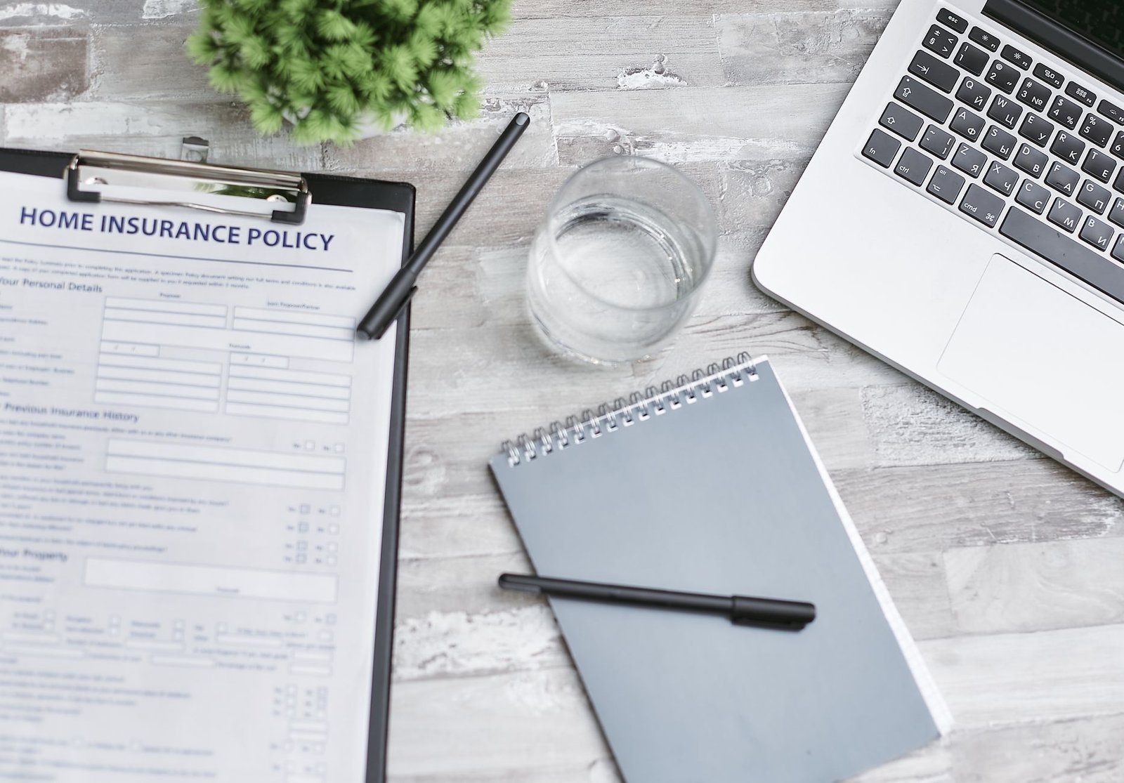 Organized desk with insurance forms and notes used to track a prior authorization request