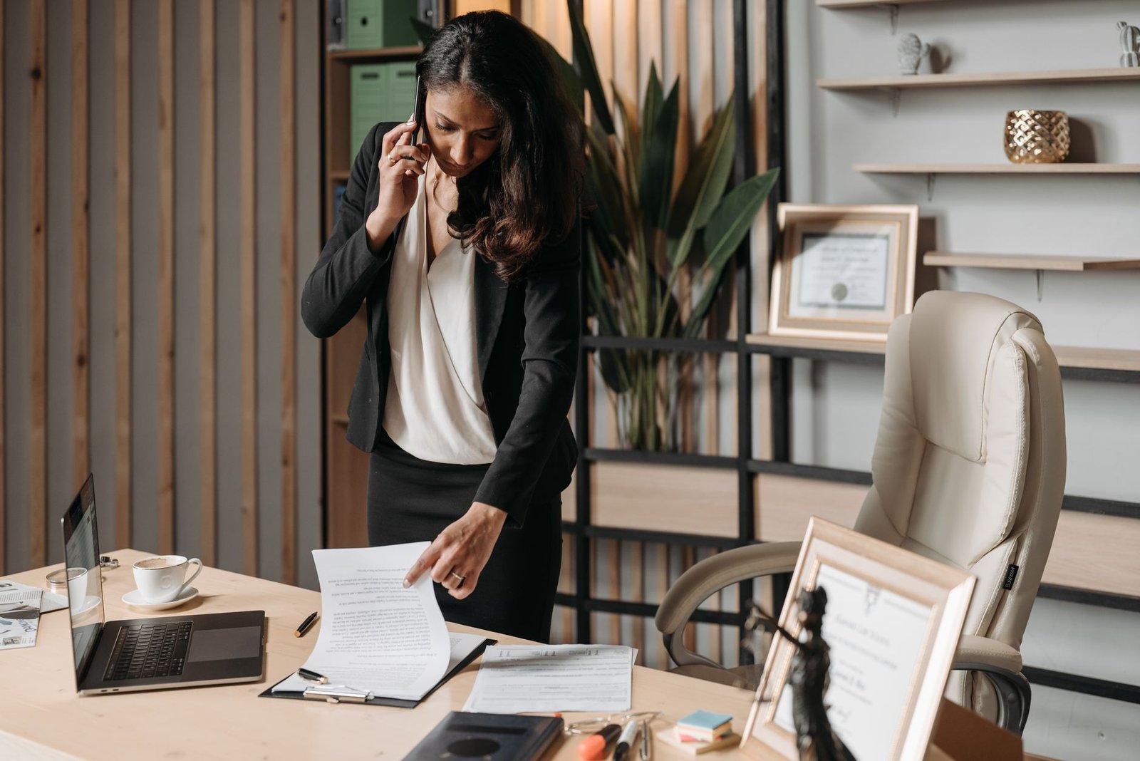 Person on the phone verifying a prior authorization with their health plan while holding paperwork