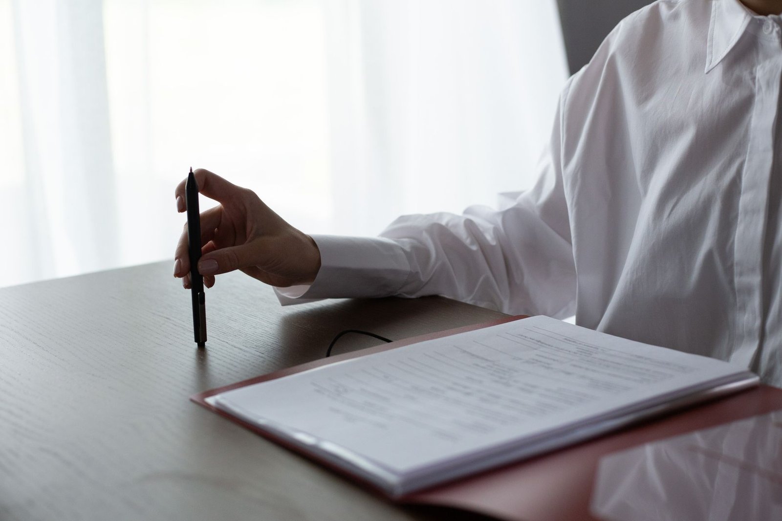 Person reviewing documents and tax forms while checking premium tax credit and cost-sharing reduction eligibility